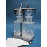A CSG&Co Electroplated Two Bottle Tantalus, of plain design with lock and key, fitted with a pair of