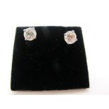 A Pair of Single Stone Diamond Earstuds, each brilliant cut stone four claw set, stamped "750",