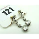 A Pair of Four Stone Diamond Set Drop Earrings, each claw set with graduated old cut stones, on