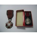 A Silver Polish Cross of Merit, a 1910 George V Coronation medal in box.