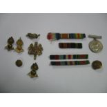 A WWII War Medal, Medal Ribbons, and a small quantity of cap badges.