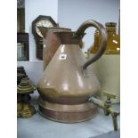 A XIX Century Two Gallon Copper, with a later brass tap together with one other copper jug. (2)