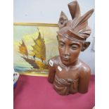 An Indonesian Carved Figure of a Boy, with impressed name on base KlungKung Bali, together with