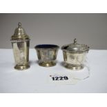 A Hallmarked Silver Three Piece Cruet Set, each of plain tapering form, with blue glass liners.
