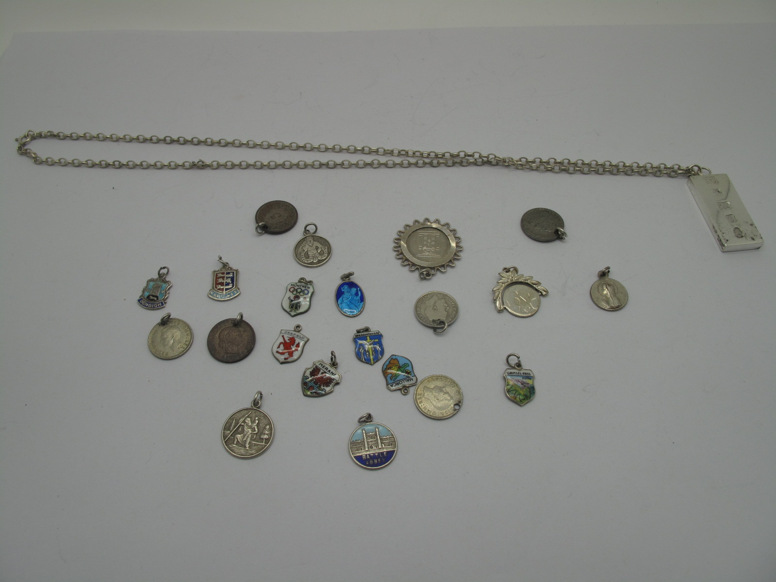 A Hallmarked Silver Ingot Pendant, on a chain; together with assorted coin and enamel shield charm