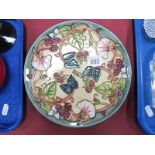 A Moorcroft Plate 1998, 689/750 decorated with berries and flowers, date in the middle of the plate,