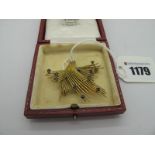 A Vintage 9ct Gold Cocktail Brooch, of abstract openwork design, with claw set highlights.