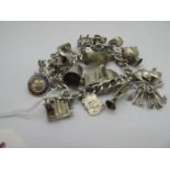 A Charm Bracelet, suspending assorted charm pendants, including pig, trumpet, pail, piano, gypsy