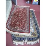 Wood Rug, with central motif, blue border with floral decoration tassel ends, 160cms x 96cms,