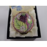 A Moorcroft Circular Enamel Trinket Box, the hinged lid painted with Autumn Berries, 4.2cm diameter,