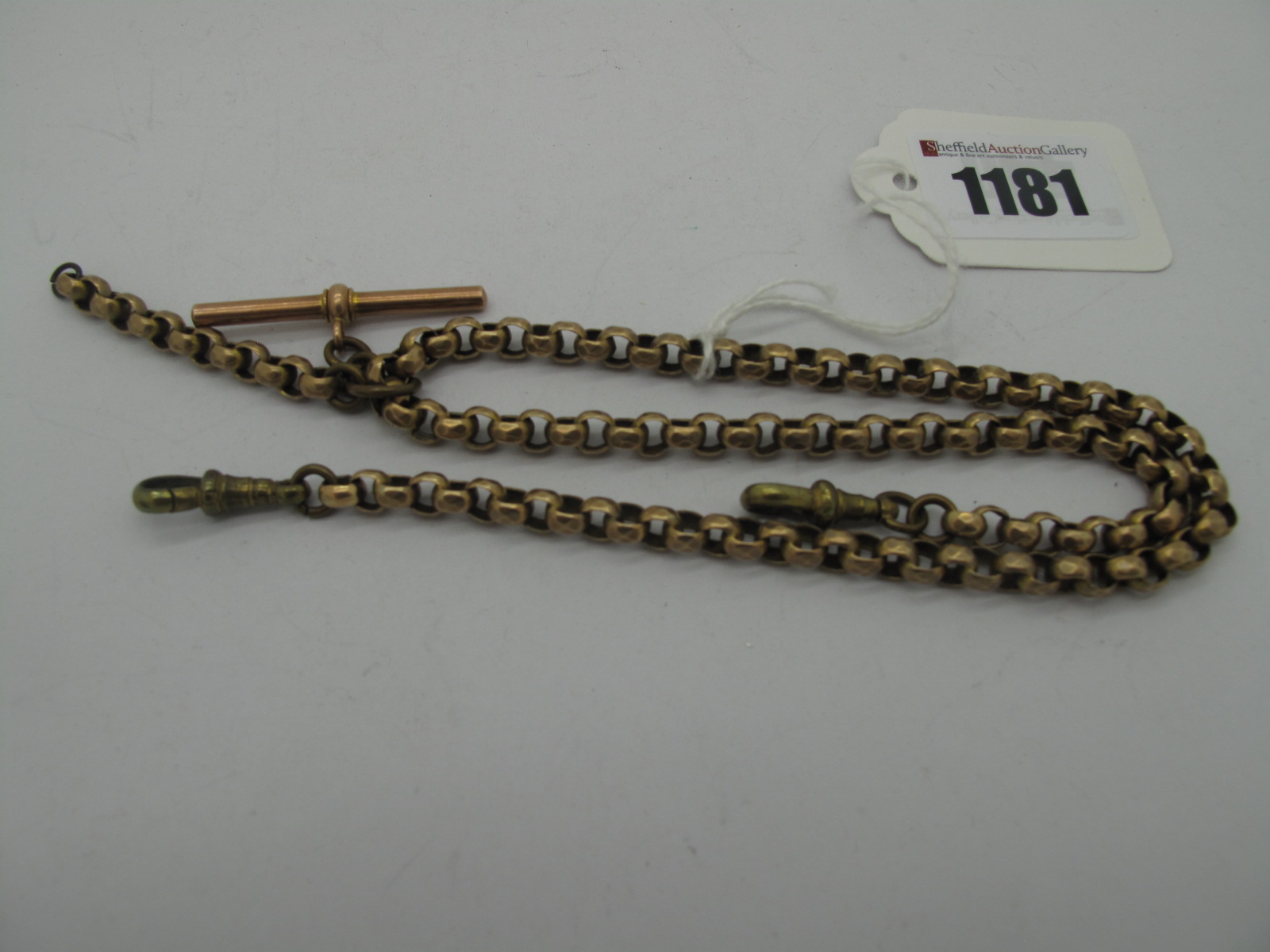 A Faceted Belcher Link Graduated Albert Chain, suspending T-bar stamped "9ct", to double swivel