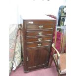 An Edwardian Mahogany Cabinet, on castors, four top drawers with brass decorative handles above a