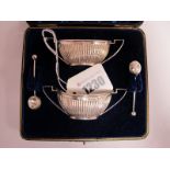 A Pair of Hallmarked Silver Salts, each of boat shape, reeded with twin angular loop handles,