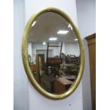 An Early XX Century Oval Shaped Gilt Mirror, with reeded decoration,and bevelled glass.