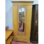 A XIX Century Pine Wardrobe, with a stepped pediment mirror door, on bracket feet.