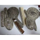 A Hallmarked Silver Backed Four Piece Dressing Table Set, all detailed in relief (comb teeth