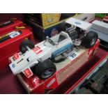 A Schuco 1:16th Scale Tin Plate Model #1075 Brabham Ford B733 Formula One Racing Car, some signs