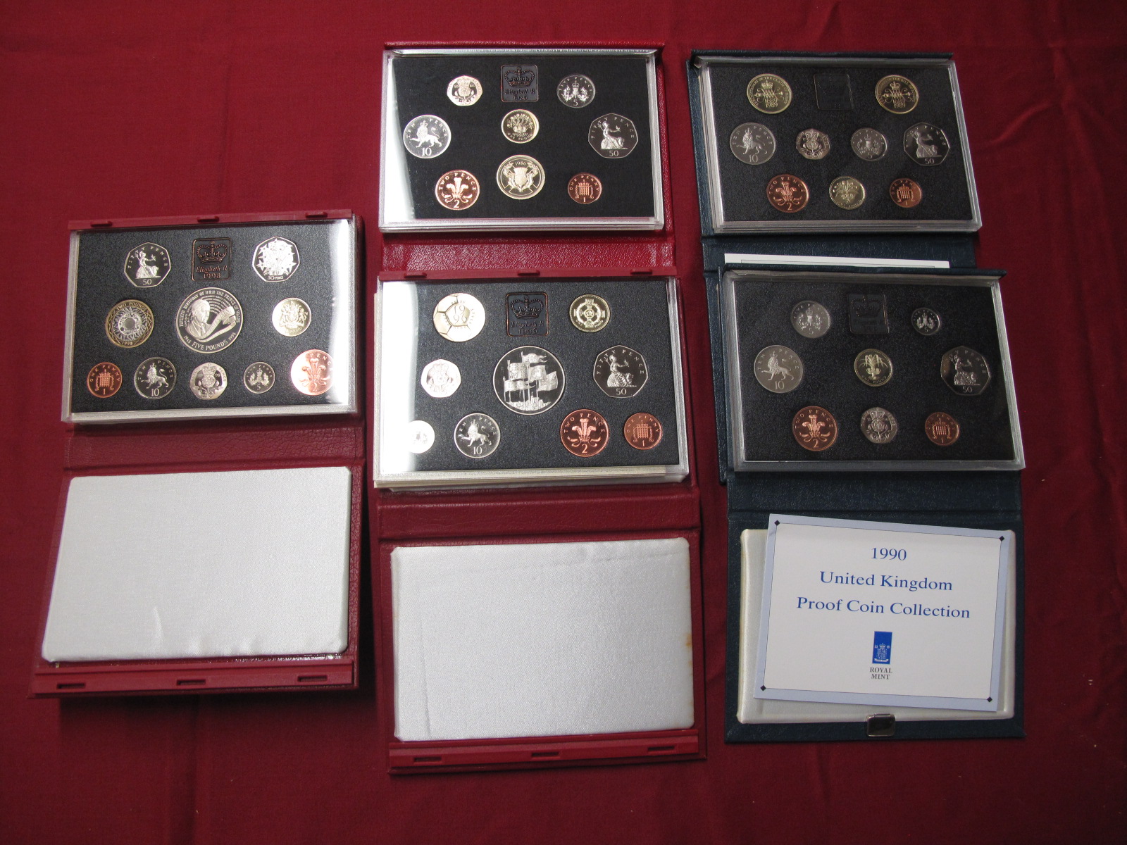 Five Royal Mint United Kingdom Proof Coin Collections, 1986, 1989, 1990, 1996, 1998, both red and