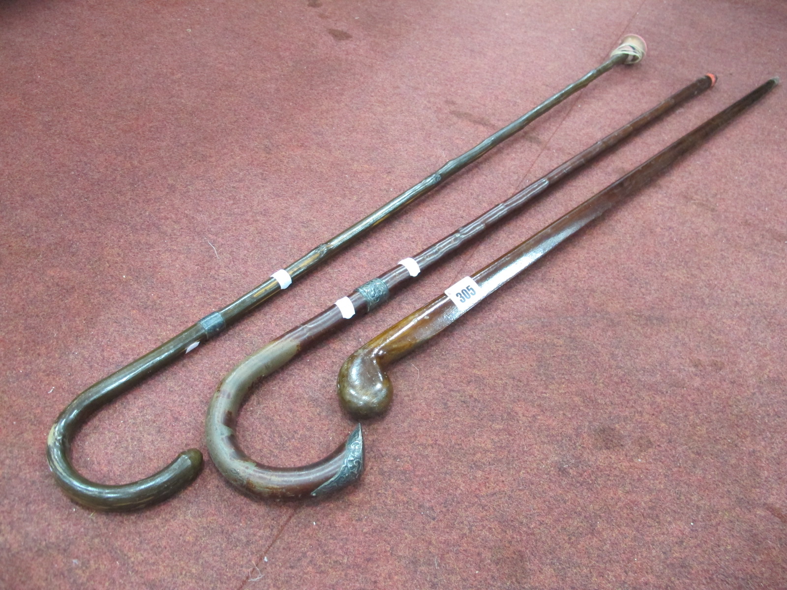 Two Crook Handled Canes, having silver collars, another with teardrop shaped body. (3)