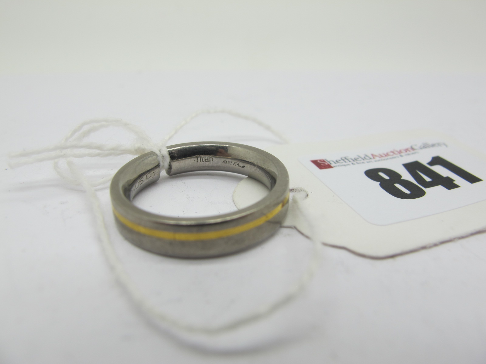 A Modern Two Colour Band Ring, with inset highlight, stamped "Titan" (finger size O).