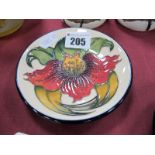 A Moorcroft Pottery Circular Coaster, painted in the 'Anna Lily' pattern, designed by Nicola Slaney,