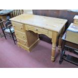 A Pine Desk with Four Drawers.