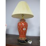 A Modern Ceramic Table Lamp, the baluster burnt orange ground with cream/gilt decoration, on a