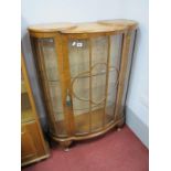 A Mid XX Century Walnut Bow Front Display Cabinet, with cloud form astragal door on squat cabriole