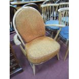 Ercol Low Easy Chair, with spindle back, on square splayed legs, bearing label.