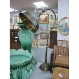 Early XX Century Desk Top Table Lamp, with a brass shade on a circular base.