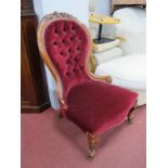 A XIX Century Walnut Ladies Parlour Chair, with pokerwork carving to the cresting of the spoon back,