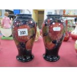 A Pair of Moorcroft Pottery Vases, of baluster form, painted in the Pomegranate pattern against a