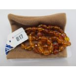 A Single Strand Necklace, of graduated faceted amber coloured beads.