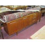 Teak Sideboard, with end cupboards flanking fall front compartment and the drawers, all with slanted