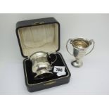 A Hallmarked Silver Christening Mug, of baluster form with scroll handle (damages) in original