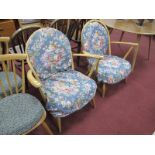 Ercol Pair of Low Easy Chairs, with spindle backs on splayed legs, bearing labels.