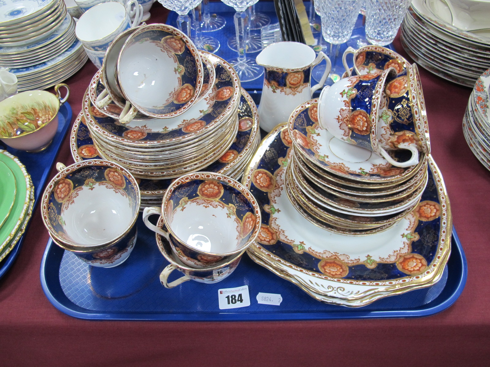 Roslyn China Tea Service, circa early XX Century, with floral motifs, blue bands, numbered 3306,