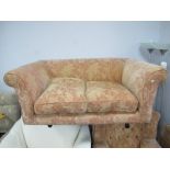 Two Seater Settee, with salmon pink floral upholstery.