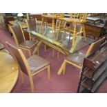 A Glass Topped Modern Table, on an 'X' frame, 80 x 180cm, plus five chairs.