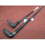 An Early XX Century Walking Stick, the stained black wood handle carved as a dog's head, with