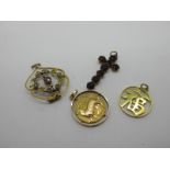 An Edwardian Openwork Pendant, circular collet set to the centre; a cross pendant claw set, a