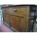 A Heavy Oak Sideboard, circa 1900, having low back, twin drawers over cupboard doors, 137cm wide.