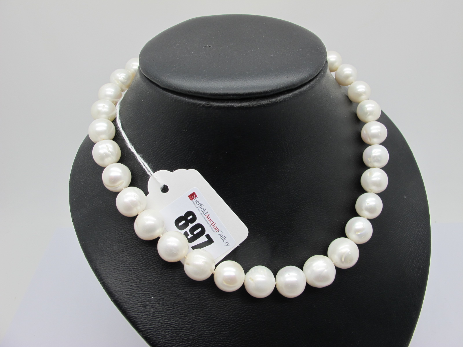 A Large Modern Single Strand Pearl Bead Necklace, the (imperfect) beads to satin finish ball