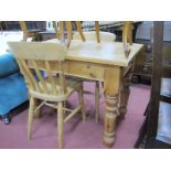 A Pine Kitchen Table, on turned legs, 101cm wide; a pair of country farmhouse chairs. (3)
