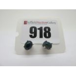 A Pair of Modern Single Stone Black Opal Earstuds, each oval cabochon four claw set, stamped "925".