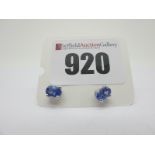 A Pair of Modern Single Stone Tanzanite Earstuds, oval four claw set, stamped "925".