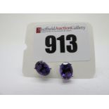 A Pair of Modern Single Stone Amethyst Earstuds, oval four claw set, stamped "925".