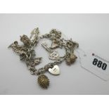 A Curb Link Charm Bracelet, to heart shape padlock clasp, suspending numerous novelty charm pendants