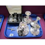 A Cased Travelling Communion Set, a crucifix; two pairs of silver plated dwarf candlesticks:- One