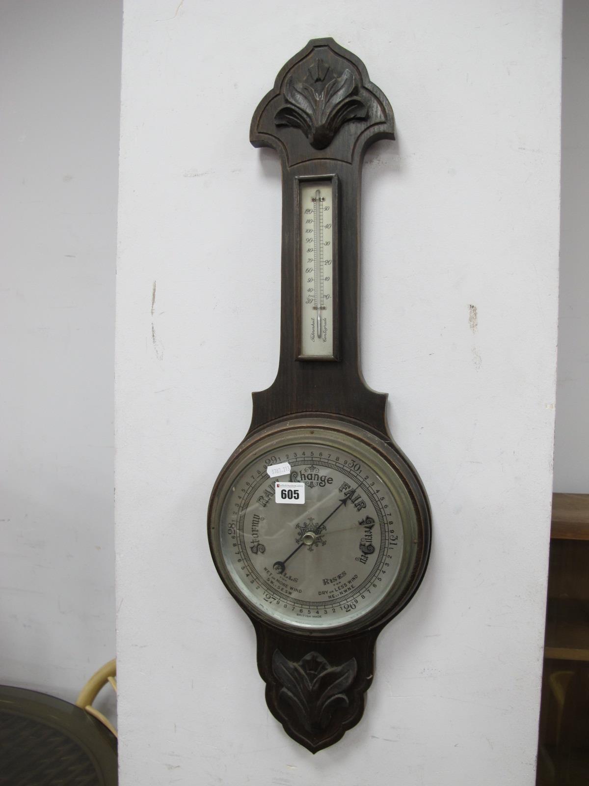 An Early XX Century Oak Cased Wall Barometer, with applied floral motifs, silvered dial and